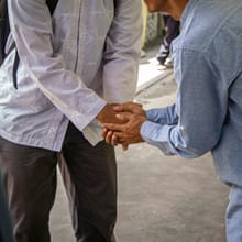Two men shaking hands in a truck yard