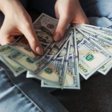 Hands fanning out cash