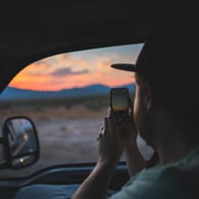 Driver holding a phone in a truck cab
