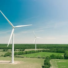 Wind turbines over green fields