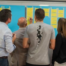 Team gathered around a whiteboard