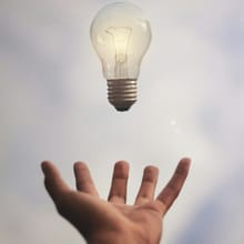 Light bulb above an open hand