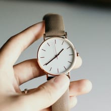Hand holding a wristwatch